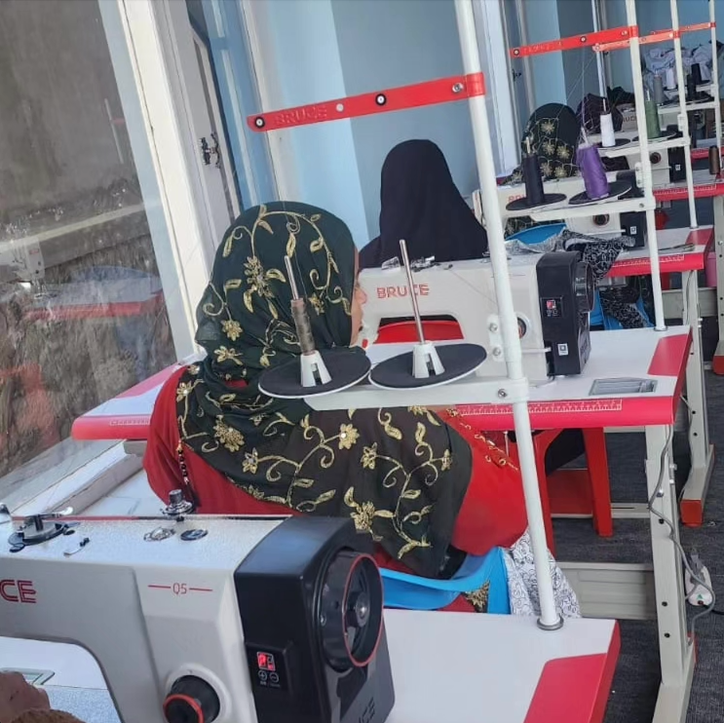 Afghan women learning to sew crackers.