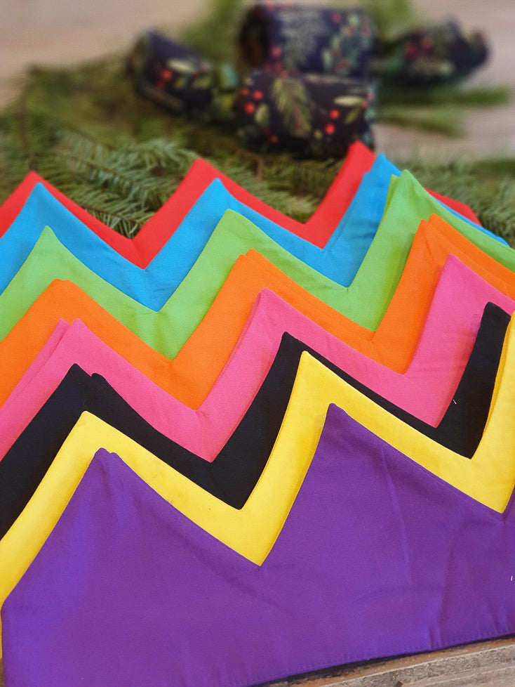 Set of eight brightly coloured reusable cotton crowns.